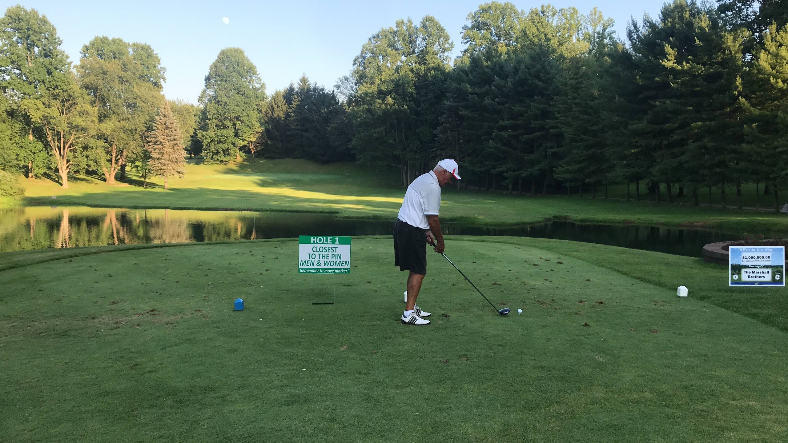 LINC golf outing participant teeing off at hole 1